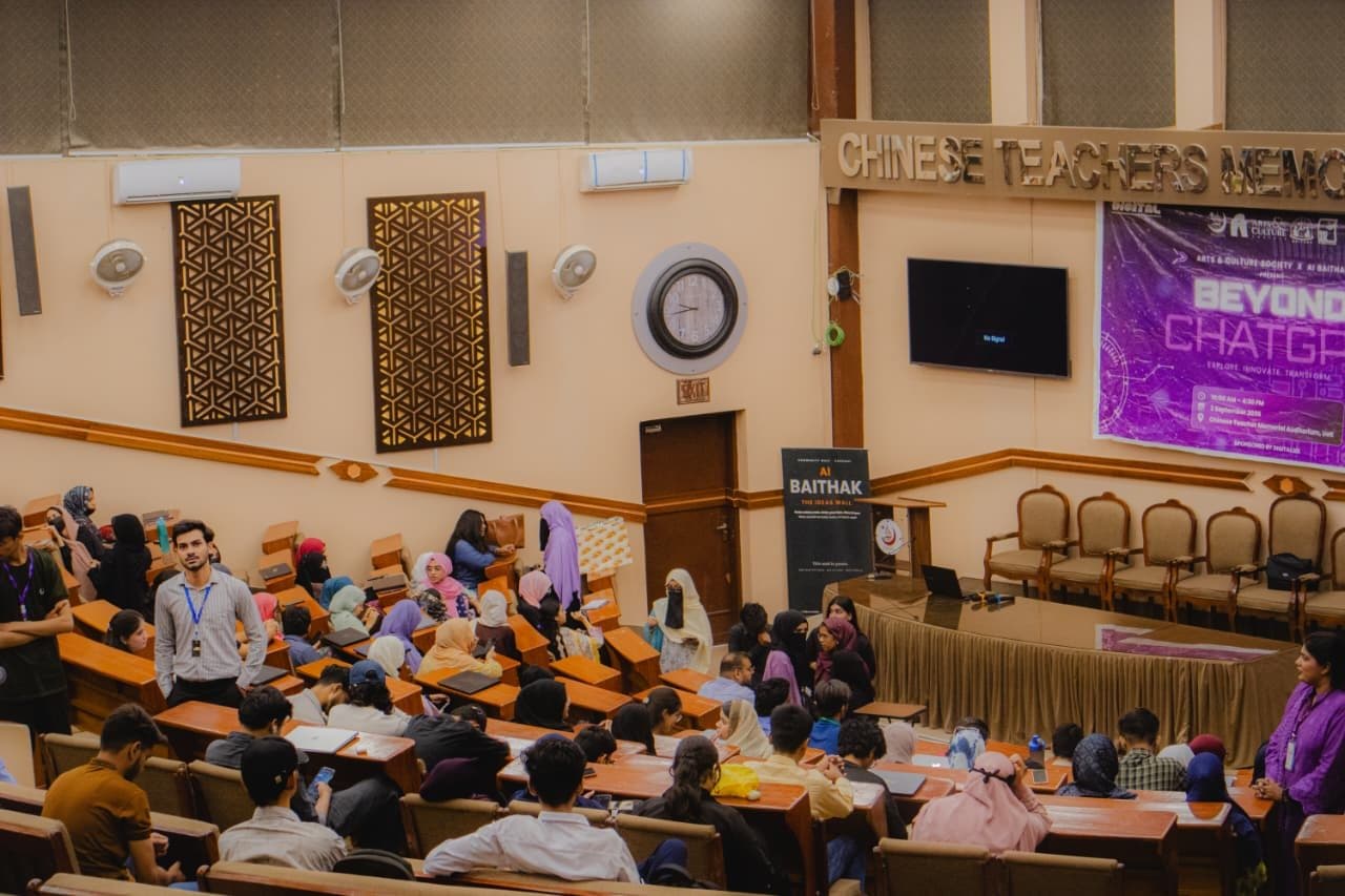 A university lecture hall filling up for Session 6