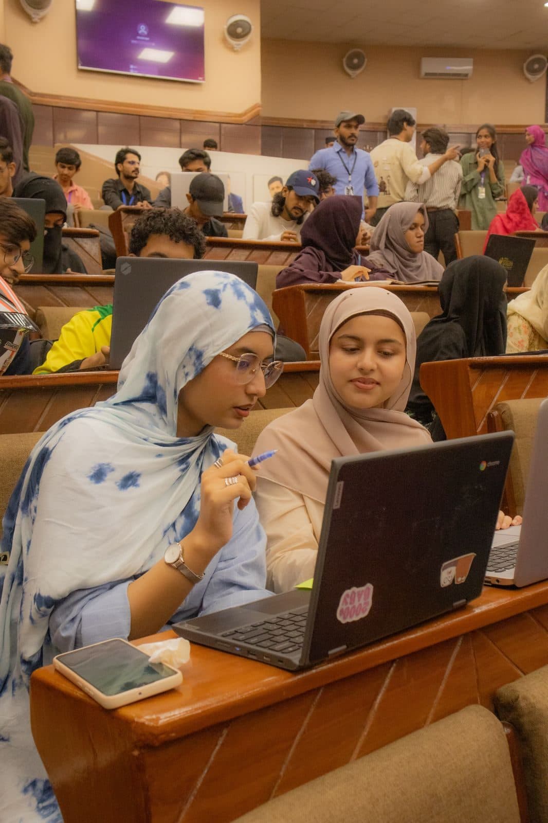 Attendees working at their laptops in the lecture hall at Session 6